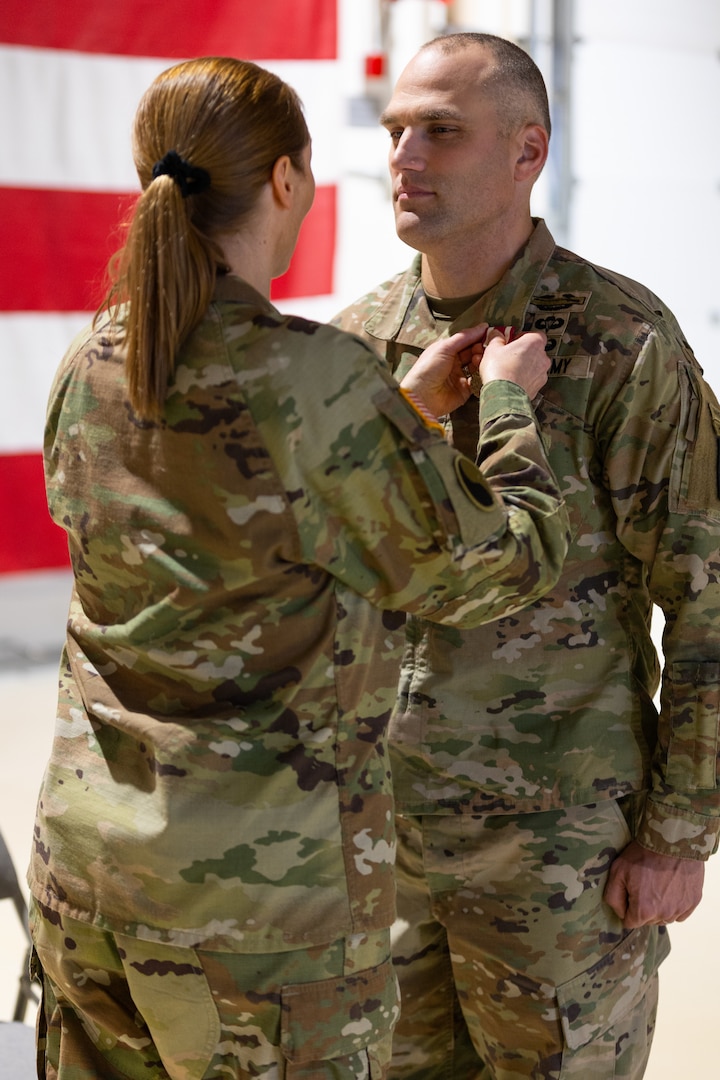 Alaska Army National Guard Lt. Col. Luke Bushatz, right, outgoing commander for the 1st Battalion, 297th Infantry Regiment, was rewarded the Meritorious Service Medal by Col. Michele Edwards, the commander of the 297th Regional Support Group, Oct. 20, 2024, at Joint Base Elmendorf-Richardson, Alaska. Bushatz was recognized for his commitment to improving his battalion’s readiness in the two years he served as commander.