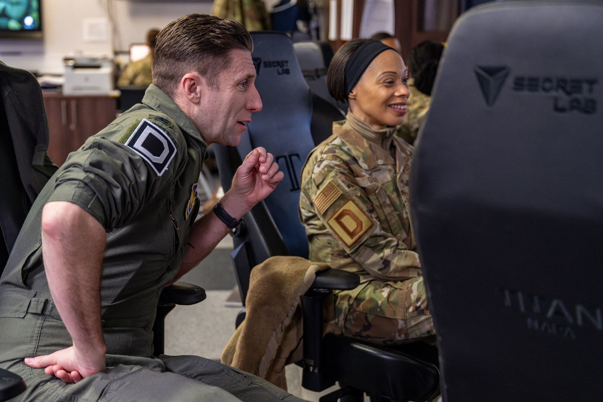 U.S. Air Force Col. Ryan Garlow, left, 100th Air Refueling Wing commander, and Chief Master Sgt. Tiffany Griego, 100th ARW command chief, look at airfield operations paperwork during a “Day in the Life” integration with the 100th OSS at RAF Mildenhall, England, Feb. 21, 2025.