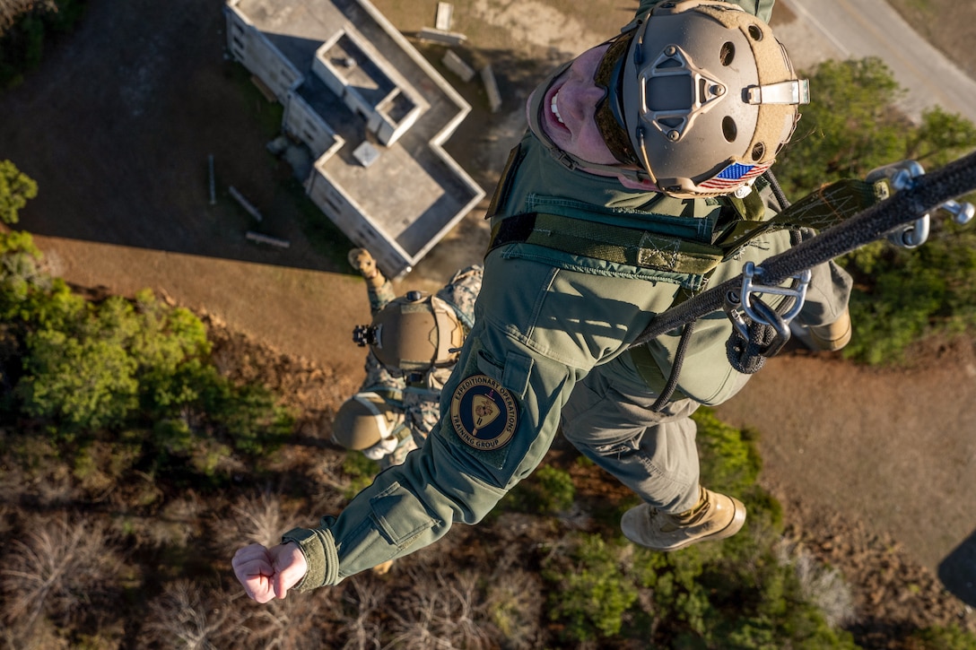 U.S. Marine Corps Capt. Sam Lorey, the assistant air officer with II Marine Expeditionary Force Expeditionary Operations Training Group (EOTG), conducts a special patrol insertion and extraction rigging drill during an EOTG Helicopter Rope Suspension Techniques Master Course at Camp Lejeune, North Carolina, Feb. 14, 2025. EOTG trains II Marine Expeditionary Force units in preparation for upcoming deployments in support of global combatant commands. (U.S. Marine Corps photo by Lance Cpl. Kyle Baskin)