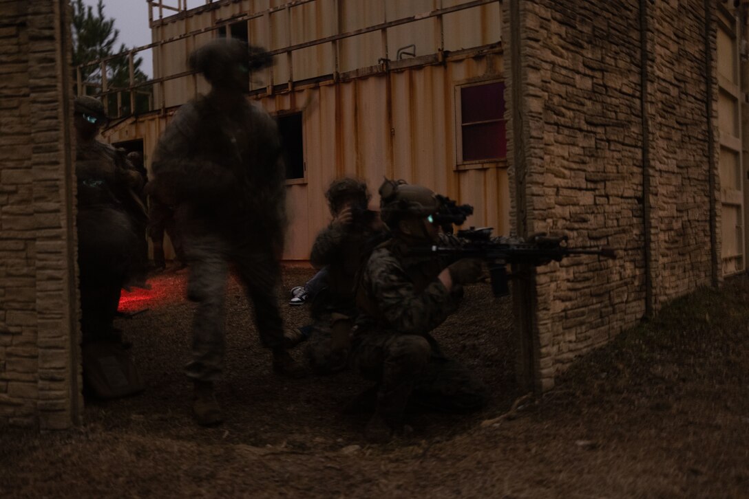 U.S. Marines with Lima Company, Battalion Landing Team 3rd Battalion, 6th Marine Regiment, 22nd Marine Expeditionary Unit, executes a simulated raid during Marine Air-Ground Task Force (MAGTF) Interoperability Exercise, on Marine Corps Base Camp Lejeune, North Carolina, Feb. 8, 2025. The raid is one of several training events within MAGTF Interoperability, a course conducted by Expeditionary Operations Training Group. This course is designed to evaluate integrated elements of the 22nd MEU across a variety of full mission profiles in a simulated peer threat environment. (U.S. Marine Corps photo by Sgt. Nathan Mitchell)