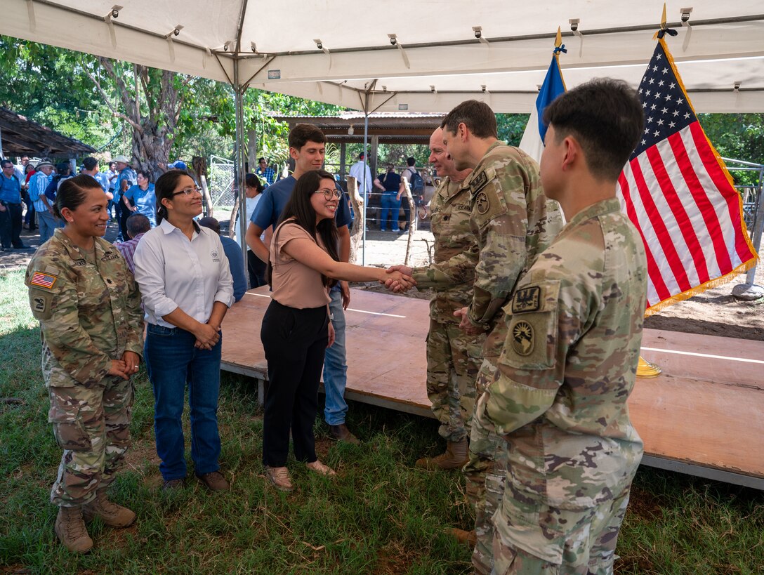 U.S. military members from the U.S. Embassy in El Salvador and Joint Task Force-Bravo greet members from the Ministry of Agriculture during a ceremony Feb. 19. The initiative aims to curb the spread of vector-borne illnesses that threaten animal and human populations. (U.S. Air Force photo)