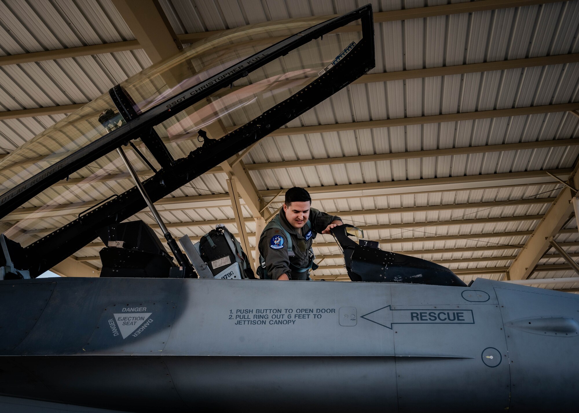 U.S. Air Force Maj. Isaiah Alley, 309th Fighter Squadron director of operations, climbs into the cockpit of a U.S. Air Force F-16 Fighting Falcon.