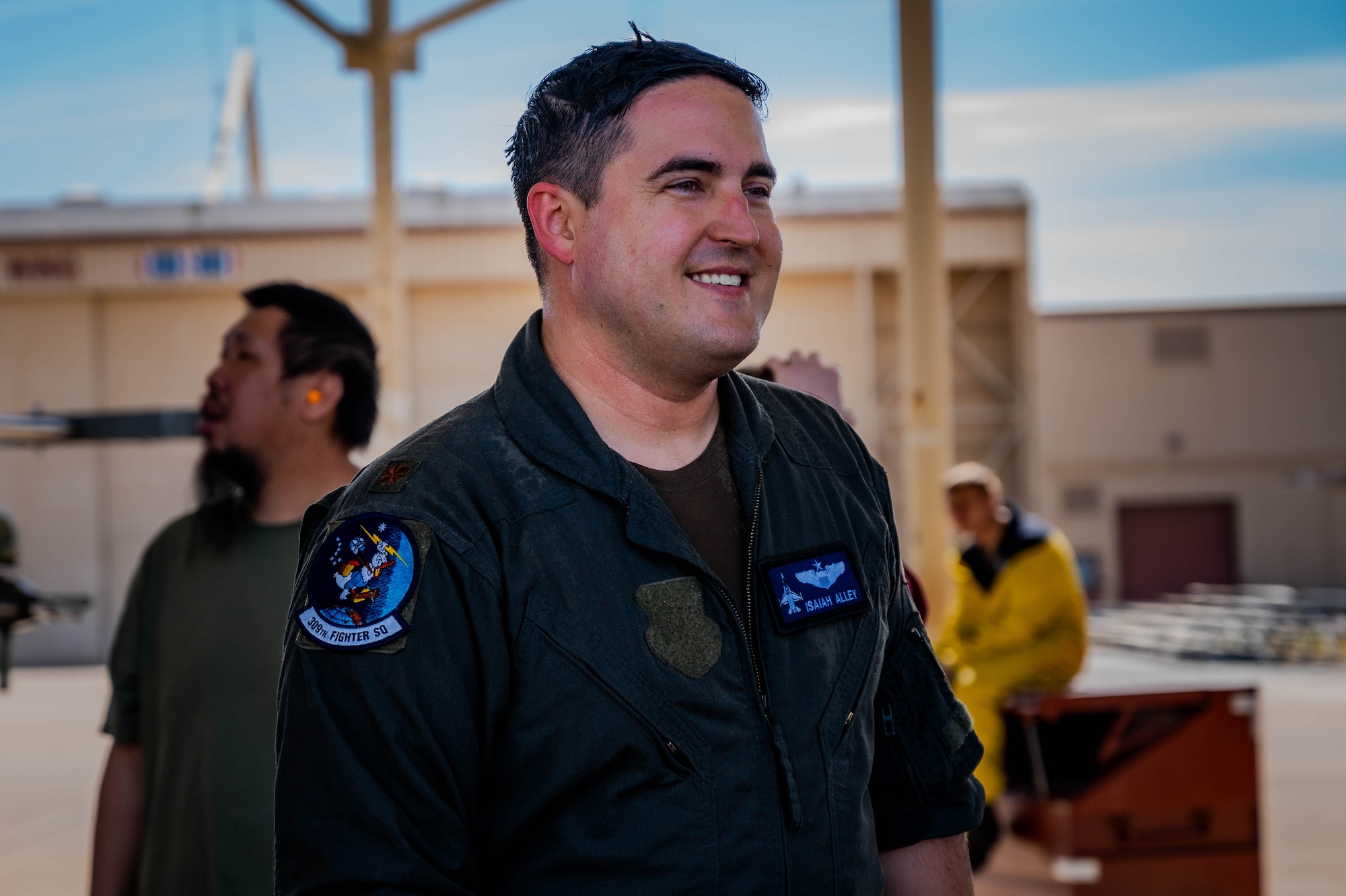 U.S. Air Force Maj. Isaiah Alley, 309th Fighter Squadron director of operations, greets friends and family following his final active-duty flight.