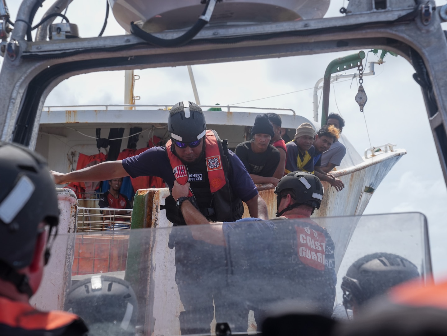 A Coast Guard member assists a Tuvalu representative onto a 26-foot over-the-horizon cutter boat from the Coast Guard Cutter Midgett (WMSL 757), after conducting a boarding under the bilateral maritime law enforcement agreement Jan. 26, 2025. Through the Midgett’s operational expertise, the Coast Guard is committed to fostering cooperation, advancing professional exchange, and enhancing bilateral maritime law enforcement with our partners. (U.S. Coast Guard photo by Petty Officer 3rd Class Jennifer Nilson)