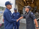 Petty Officer 3rd Class Raymond Vasquez-Carranza, a storekeeper aboard the Coast Guard Cutter Midgett (WMSL 757) and Royal New Zealand Navy Able Writer Jordi Kotuhi-Brown shake hands as Brown departs the Midgett after sailing onboard, in Wellington, New Zealand Feb. 10, 2025. The United States and New Zealand maintain close cooperation in supporting a Pacific islands region that is peaceful, secure, prosperous, and resilient. (U.S. Coast Guard photo by Petty Officer 3rd Class Jennifer Nilson)