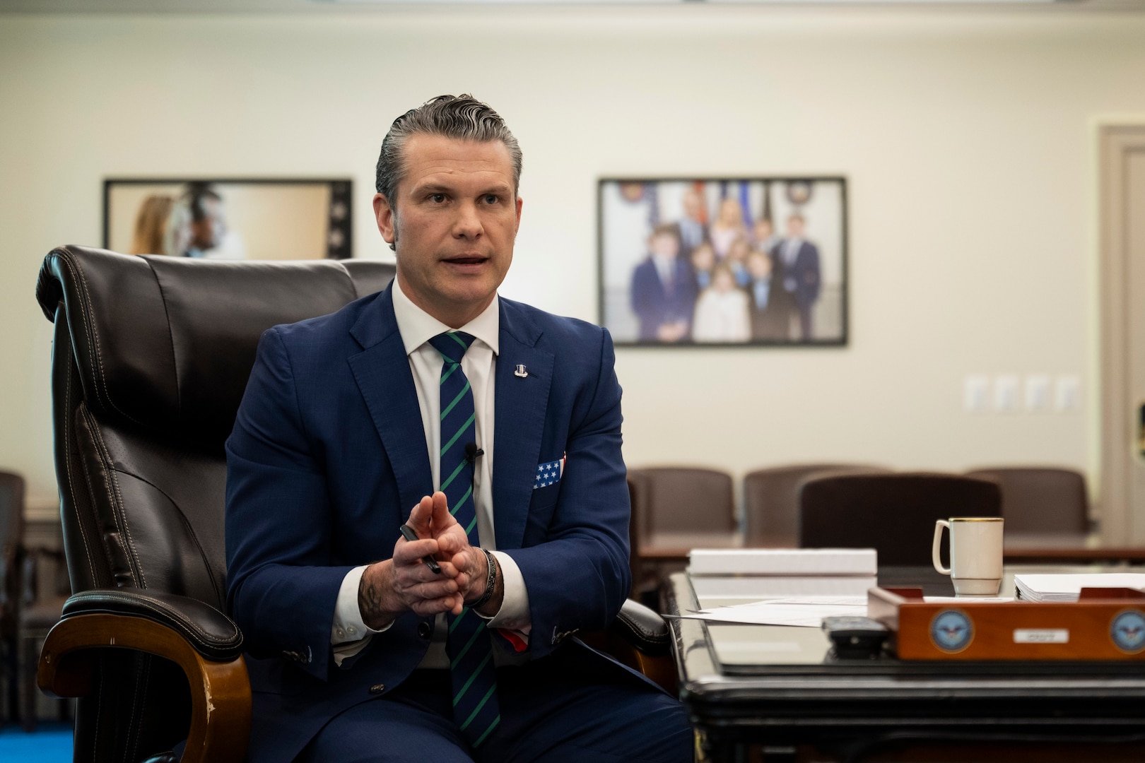 Defense Secretary Pete Hegseth delivers remarks while seated in an office.