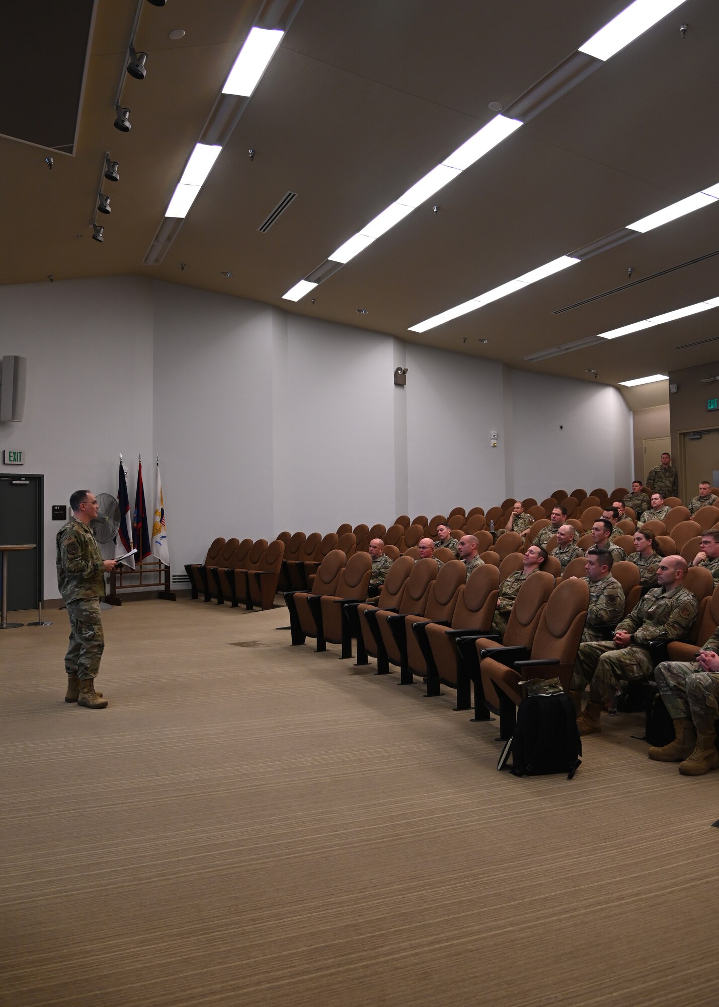 532nd training squadron military students list to a colonel speak about the 21m career field during a brief in an auditorium