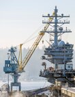 Samsung Portal Crane 62 sits by the USS Ronald Reagan (CVN 76) mooored at Pier Bravo, Jan 21, Puget Sound Naval Shipyard & Intermediate Maintenance Facility Bremerton.

(U.S Navy Photo by Wendy Hallmark)