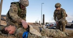 U.S. Air Force Tech. Sgt. Charles Guthrie, right, instructs U.S. Air Force Staff Sgt. William Shimel as he provides care to U.S. Air Force Staff Sgt. Spencer Parmelee during total combat casualty care training at Buckley Space Force Base, Aurora, Colorado, Jan. 29, 2025. The Airmen are 140th Medical Group aerospace medical technicians.