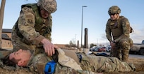 U.S. Air Force Tech. Sgt. Charles Guthrie, right, instructs U.S. Air Force Staff Sgt. William Shimel as he provides care to U.S. Air Force Staff Sgt. Spencer Parmelee during total combat casualty care training at Buckley Space Force Base, Aurora, Colorado, Jan. 29, 2025. The Airmen are 140th Medical Group aerospace medical technicians.