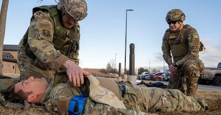 U.S. Air Force Tech. Sgt. Charles Guthrie, right, instructs U.S. Air Force Staff Sgt. William Shimel as he provides care to U.S. Air Force Staff Sgt. Spencer Parmelee during total combat casualty care training at Buckley Space Force Base, Aurora, Colorado, Jan. 29, 2025. The Airmen are 140th Medical Group aerospace medical technicians.