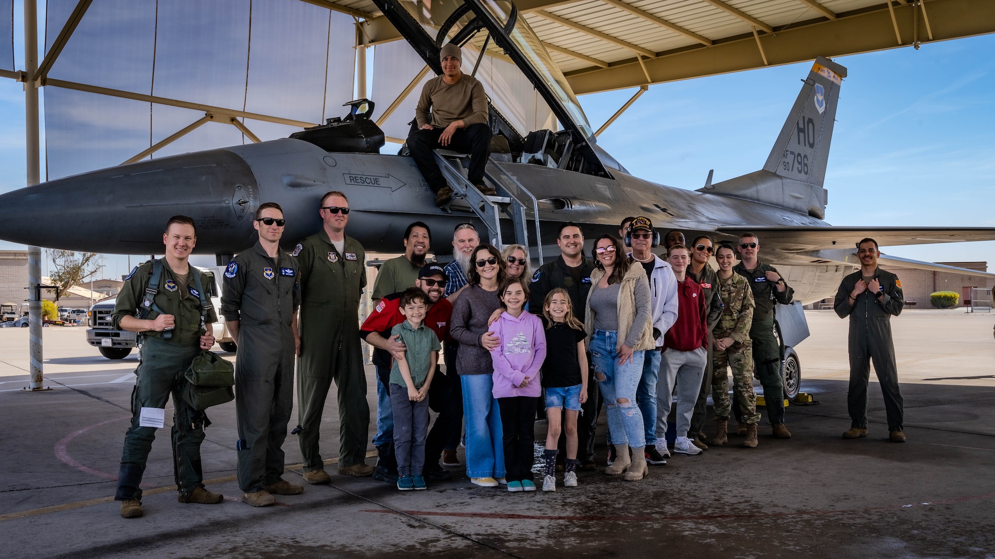 U.S. Air Force Maj. Isaiah Alley, 309th Fighter Squadron director of operations, poses for a photo with family and friends following his final active-duty flight.