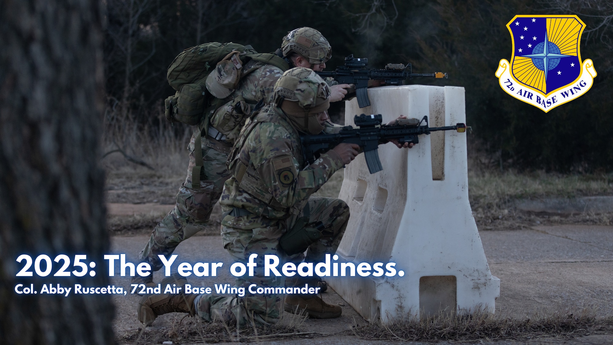 Two Airmen fire rifles from behind barricade