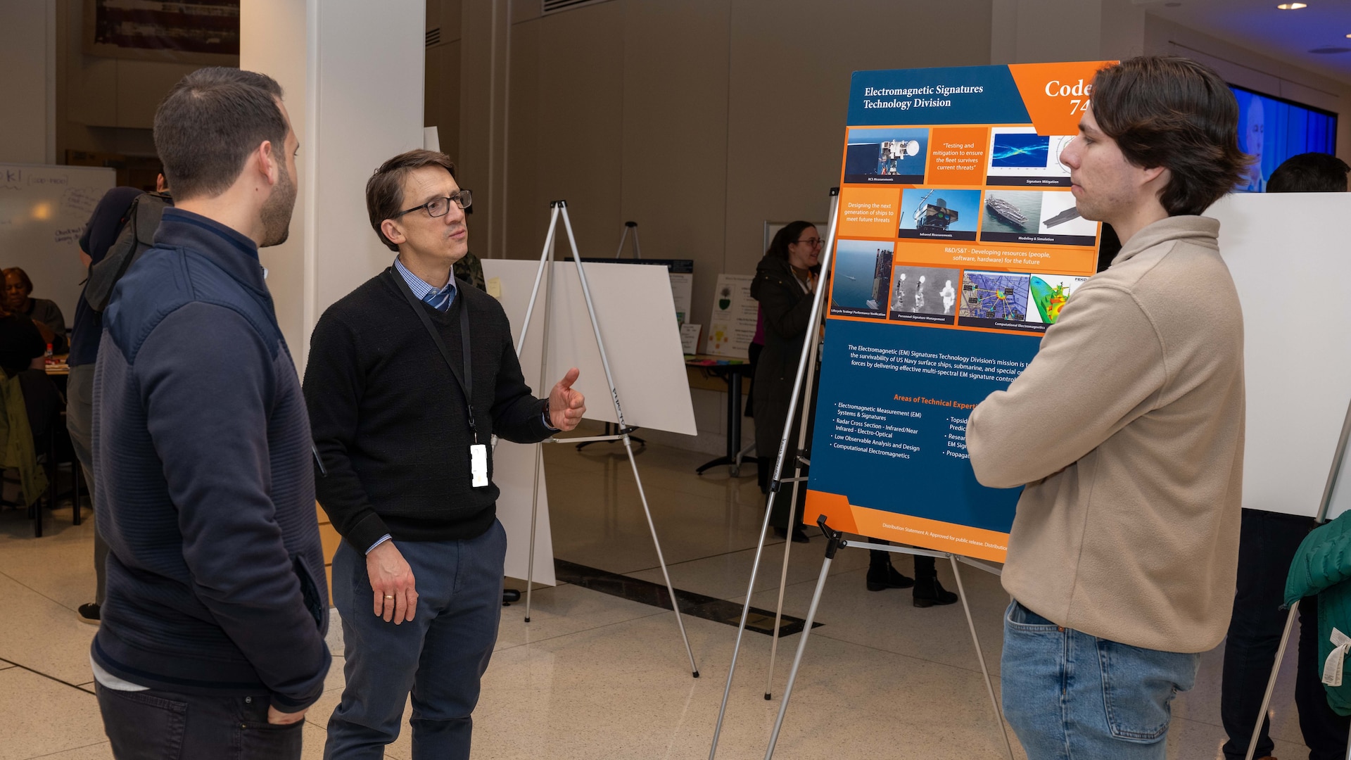 Attendees explore exhibits during a poster session and open house of an enterprise-wide event themed “Design Your Future,” held at Naval Surface Warfare Center, Carderock Division to commemorate Engineers Week, Feb. 18, 2025.