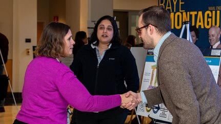 Naval Surface Warfare Center, Carderock Division's Chief Technology Officer, Dr. Elissa Trueman, meets with attendees during the poster session and open house of an enterprise-wide event themed “Design Your Future,” held at Carderock' Raye Montague Center to commemorate Engineers Week, Feb. 18, 2025.