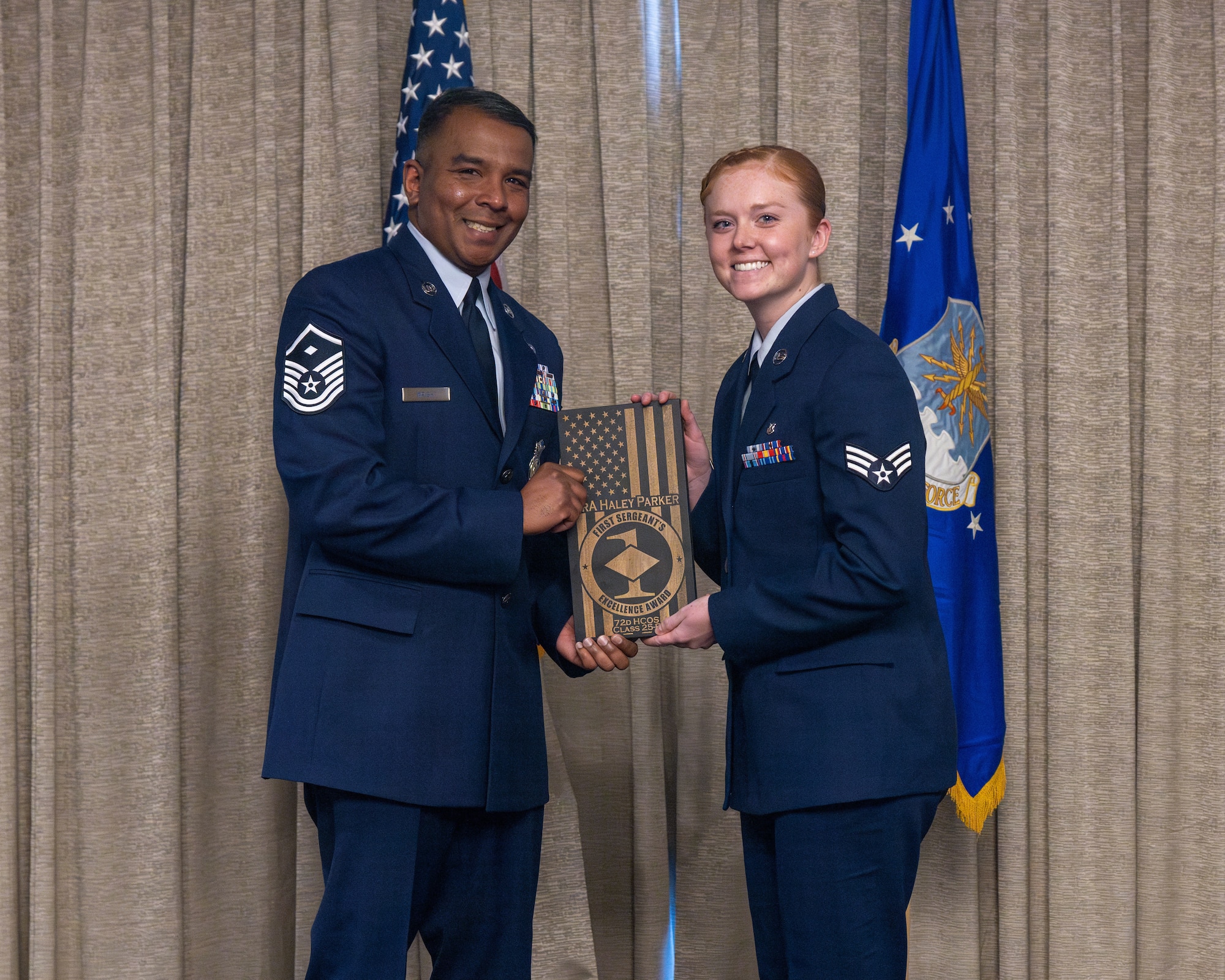 airman accepts award at airman leadership school graduation
