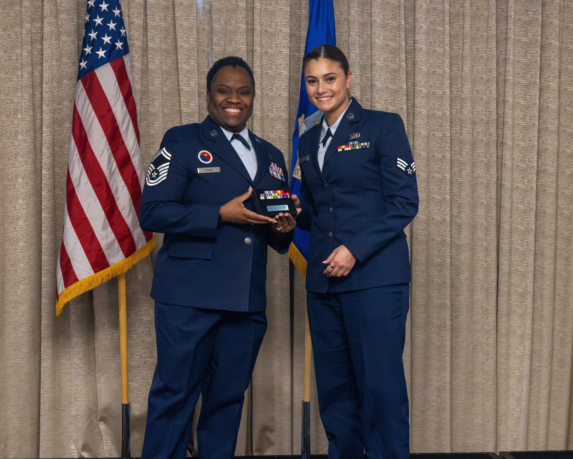 airman accepts award at airman leadership school graduation