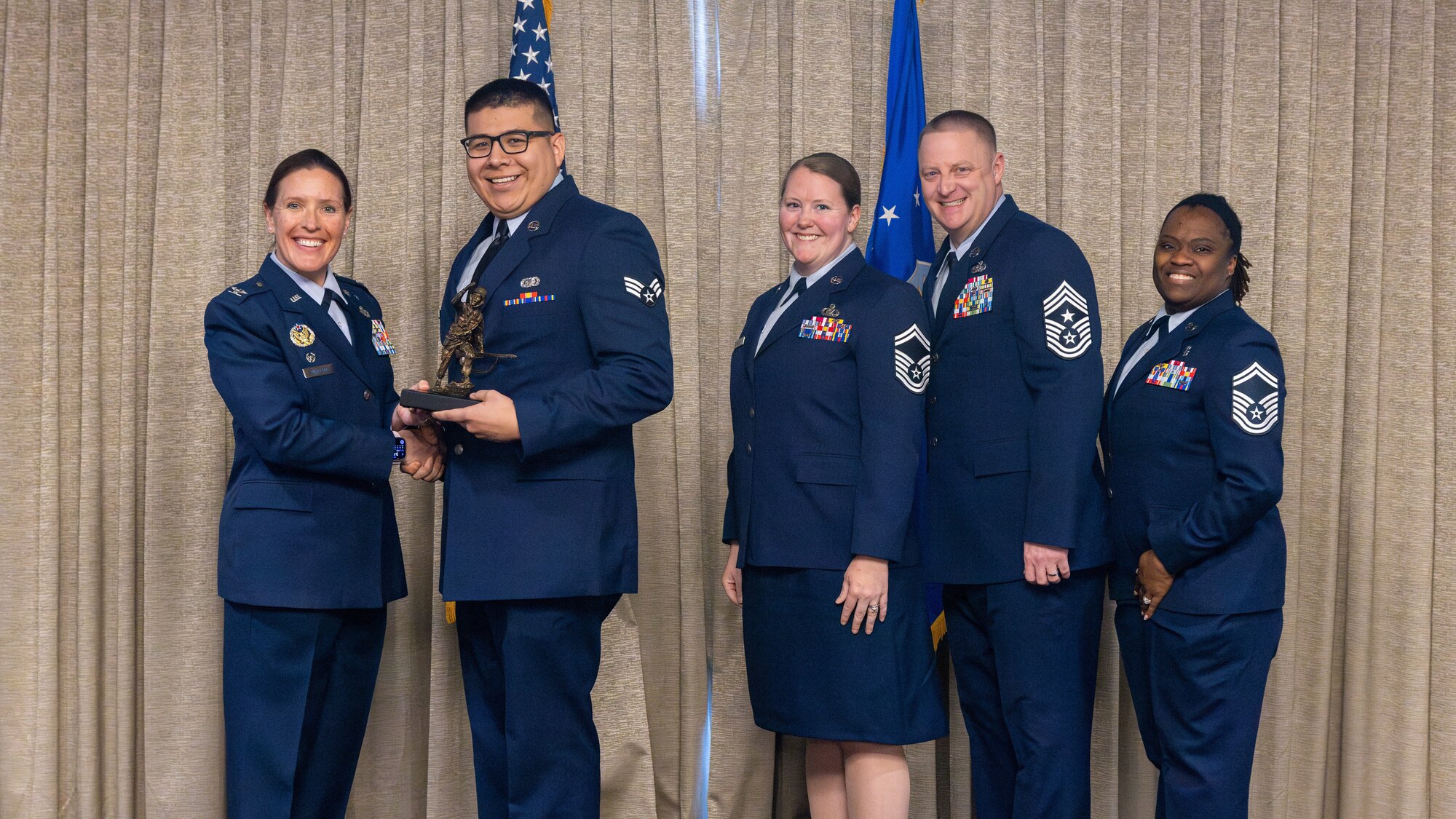 airman accepts award at airman leadership school graduation