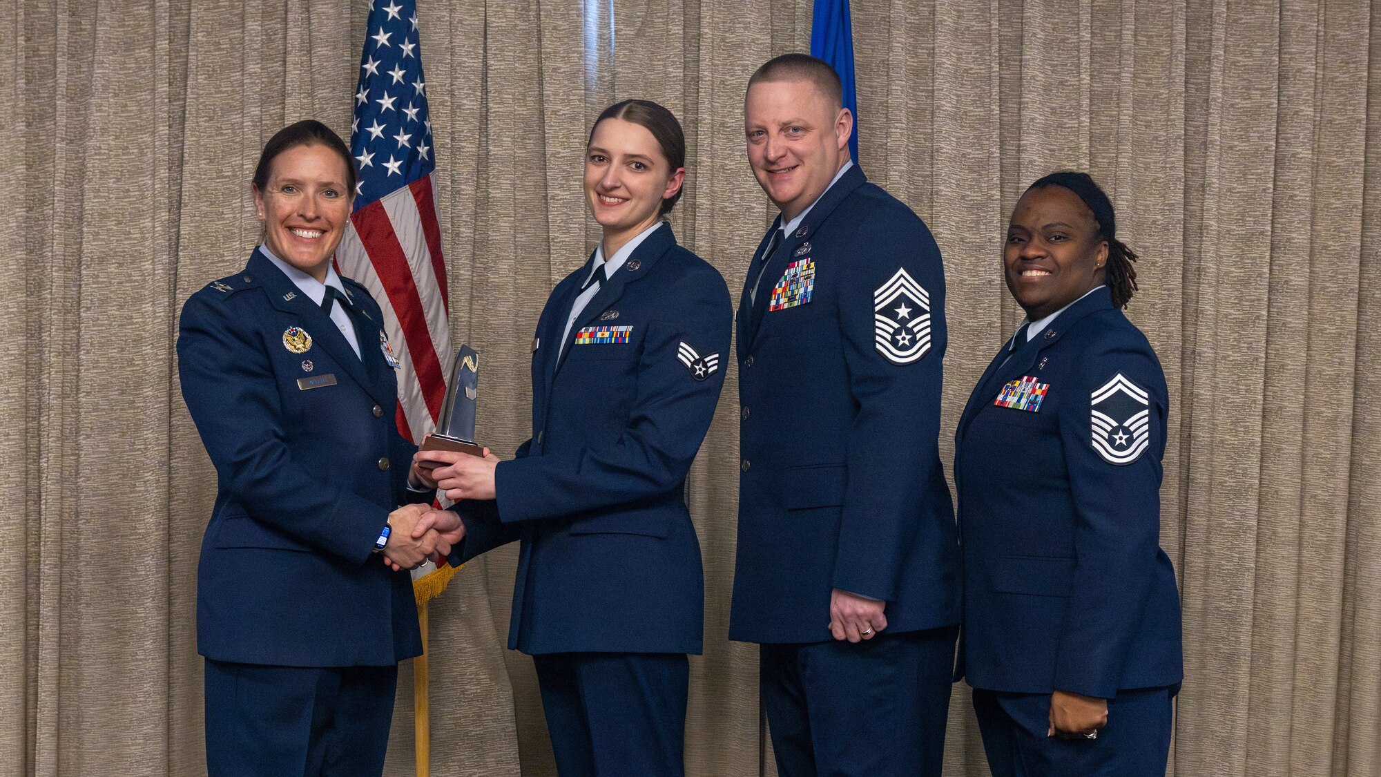 airman accepts award at airman leadership school graduation