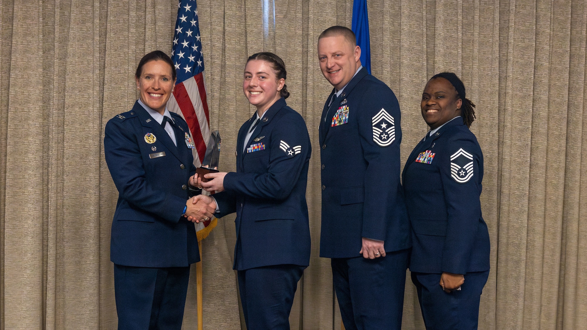 airman accepts award at airman leadership school graduation