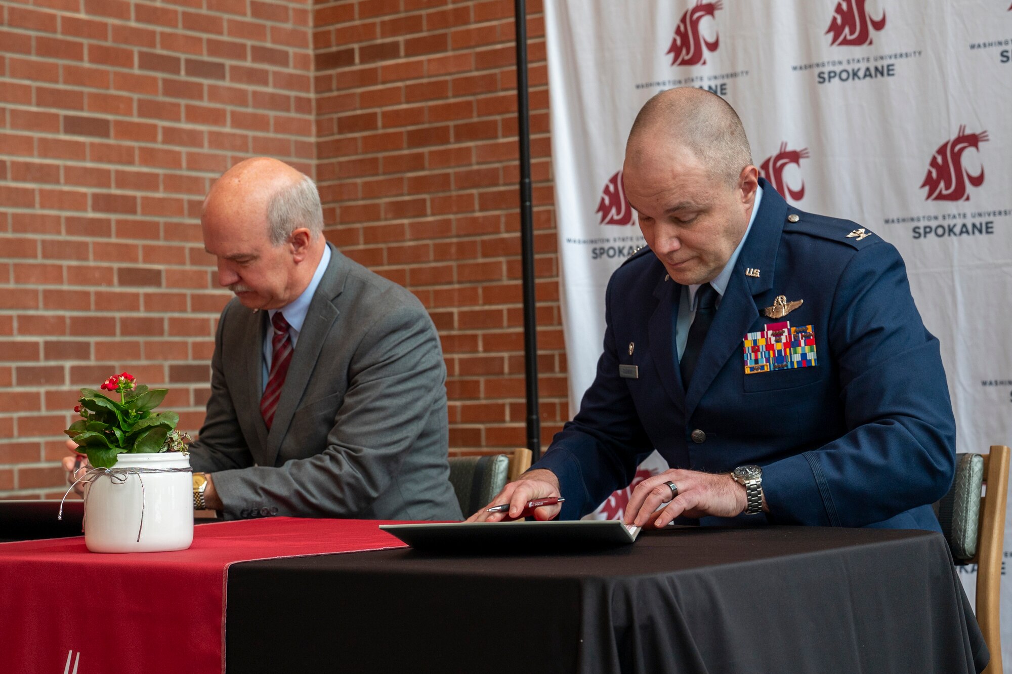 People sign a piece of paper