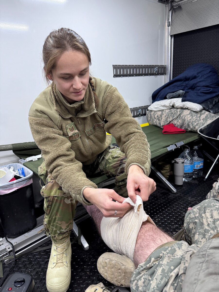 Tech. Sgt. Gabriella Larson, an aerospace medical specialist assigned to the 148th Fighter Wing, Minnesota Air National Guard, applies first aid to a service member during the Air National Guard’s Cold Weather Operations Course at Camp Ripley Training Center, Minn., Feb. 5, 2025.  The course, attended by 70 students from 37 Air National Guard wings, was planned, and hosted by the Minnesota National Guard’s 148th Fighter Wing. The course was designed to prepare service members for deployments to cold weather regions and assist in planning missions with the goal of mitigating cold weather injuries. (U.S. Air National Guard photo by Audra Flanagan)