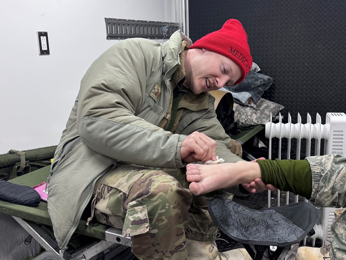 Master Sgt. Sean Prouty, an aerospace medical specialist assigned to the 148th Fighter Wing, Minnesota Air National Guard, applies first aid to a service member during the Air National Guard’s Cold Weather Operations Course at Camp Ripley Training Center, Minn., Feb. 6, 2025.  The course, attended by 70 students from 37 Air National Guard wings, was planned, and hosted by the Minnesota National Guard’s 148th Fighter Wing. The course was designed to prepare service members for deployments to cold weather regions and assist in planning missions with the goal of mitigating cold weather injuries. (U.S. Air National Guard photo by Audra Flanagan)