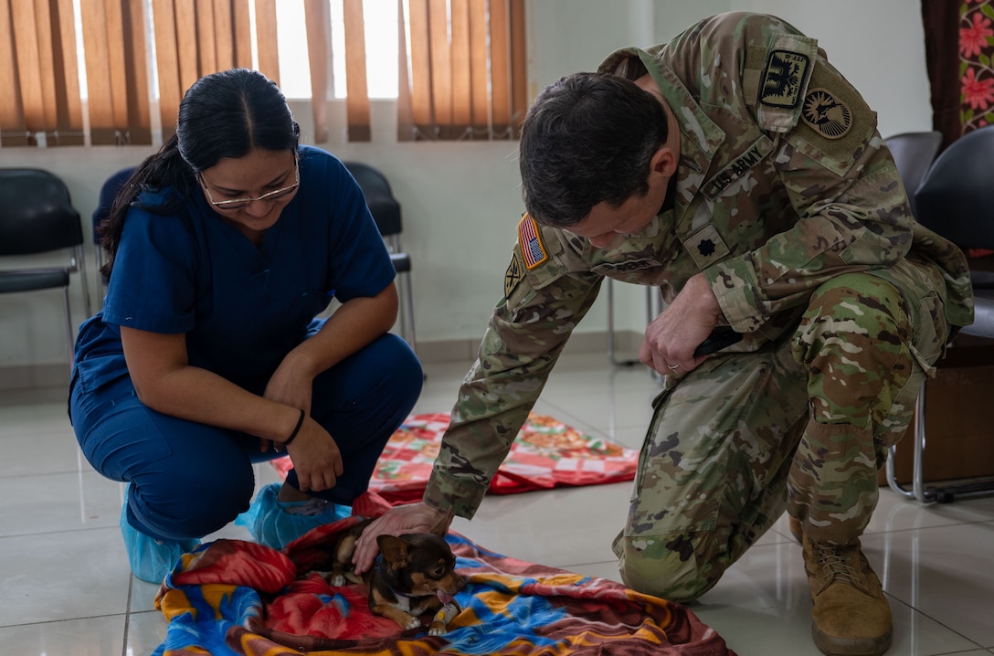 U.S. Army Lt. Col. Carl Schreier, Army Forces Battalion commander, comforts a patient as they recover following surgery during a JTF-Bravo led VETRETE in Ahuachapan, El Salvador Feb. 19. The VETRETE provided U.S. military personnel with valuable experience in austere environments while simultaneously addressing the significant issue of animal overpopulation in El Salvador. (U.S. Air Force photo)