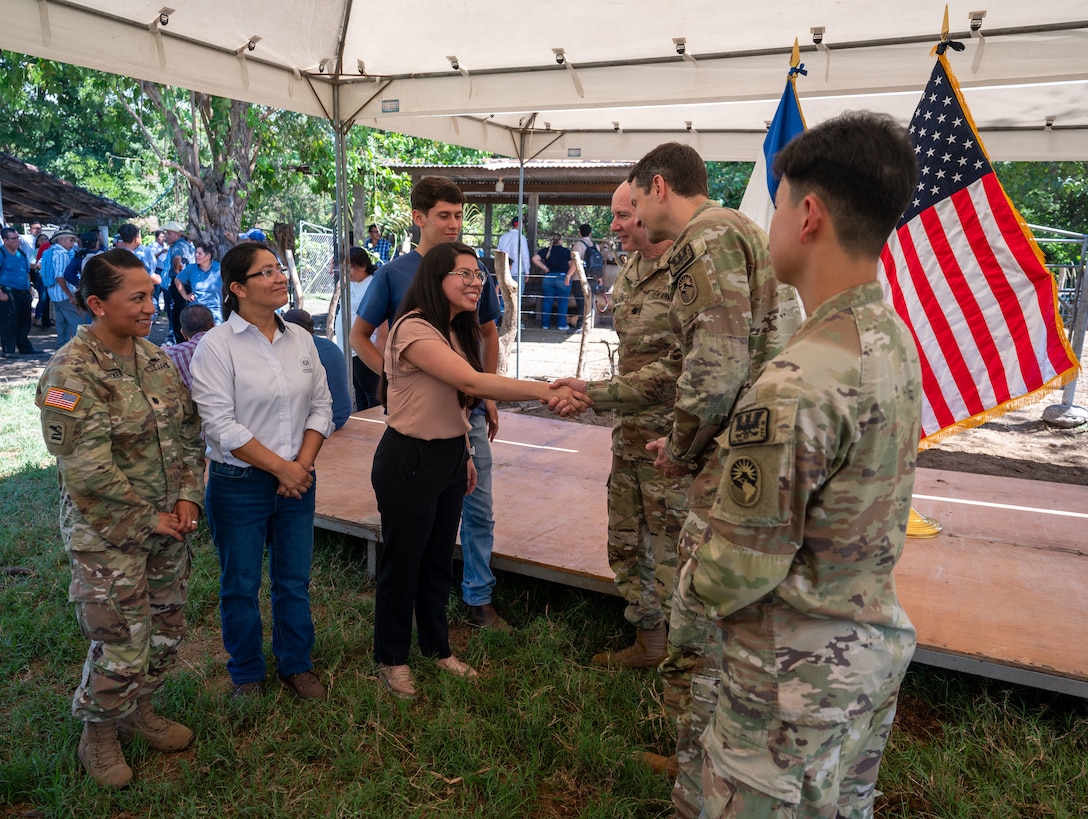 U.S. military members from the U.S. Embassy in El Salvador and Joint Task Force-Bravo greet members from the Ministry of Agriculture during a ceremony Feb. 19. The initiative aims to curb the spread of vector-borne illnesses that threaten animal and human populations. (U.S. Air Force photo)