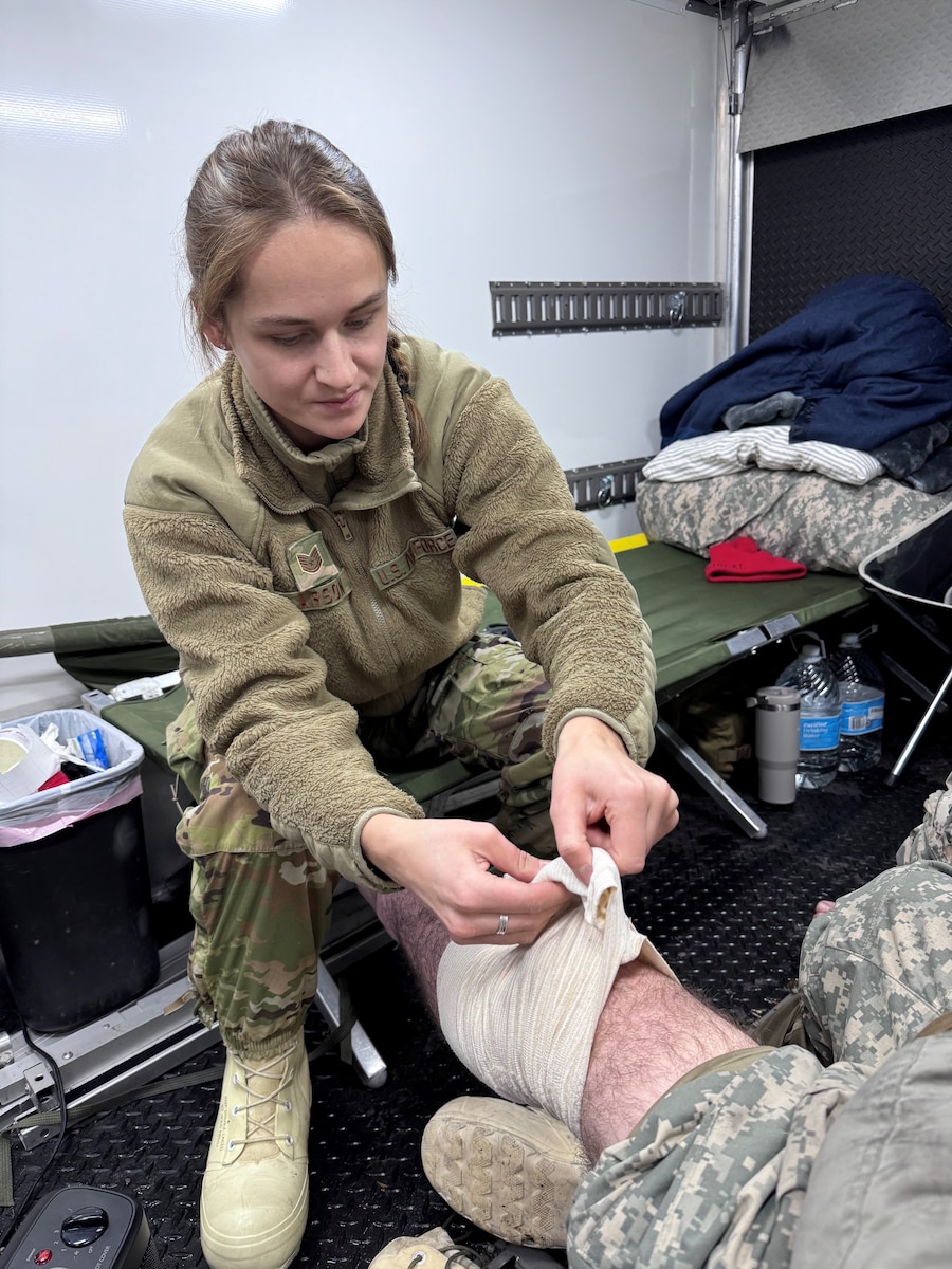 Tech. Sgt. Gabriella Larson, an aerospace medical specialist assigned to the 148th Fighter Wing, Minnesota Air National Guard, applies first aid to a service member during the Air National Guard’s Cold Weather Operations Course at Camp Ripley Training Center, Minn., Feb. 5, 2025.  The course, attended by 70 students from 37 Air National Guard wings, was planned, and hosted by the Minnesota National Guard’s 148th Fighter Wing. The course was designed to prepare service members for deployments to cold weather regions and assist in planning missions with the goal of mitigating cold weather injuries. (U.S. Air National Guard photo by Audra Flanagan)