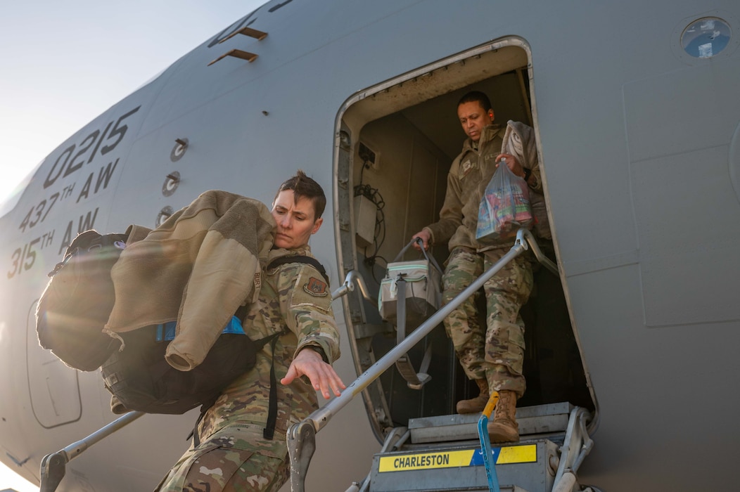 Photo of Airmen departing aircraft.