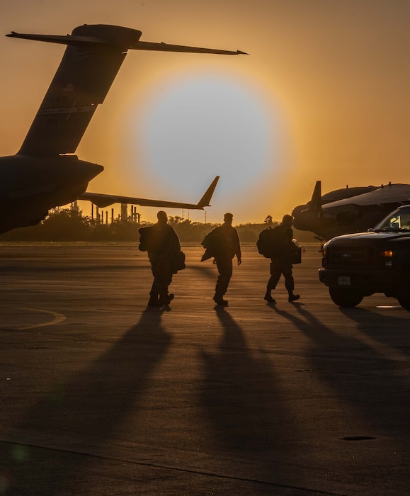 Photo of three Airmen walking