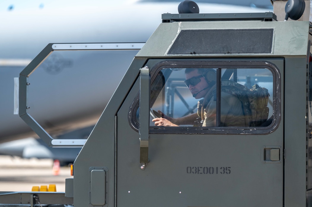 Photo of Airman driving an unloader