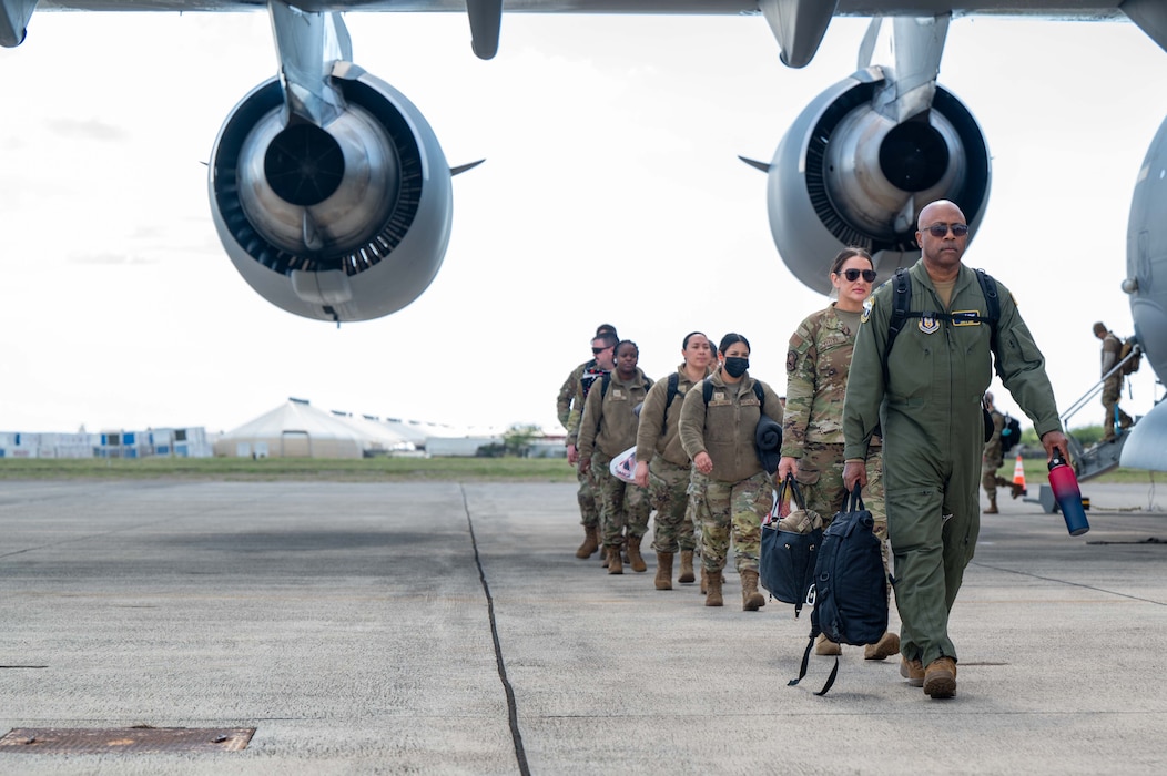 Photo of Airmen departing a C-17.