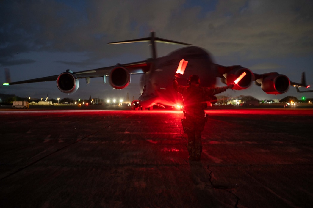 Photo of Airmen marshalling a C-17