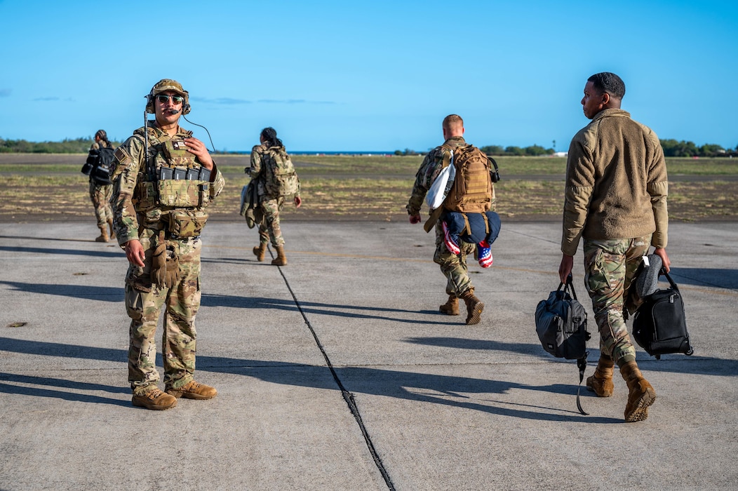 Photo of Airman directing personnel