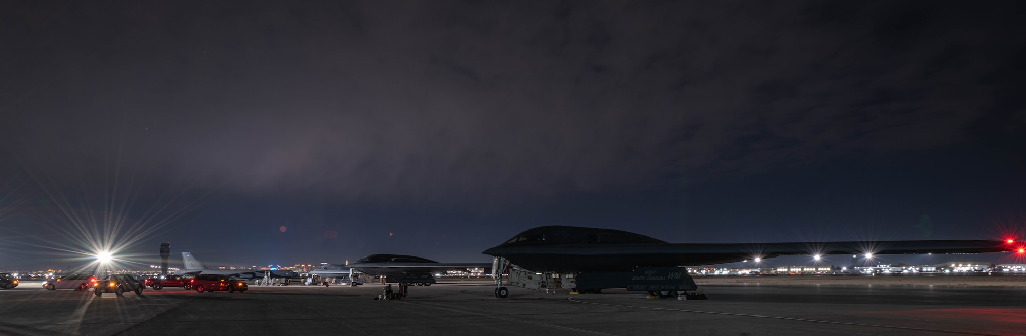 Three B-2 Spirit stealth bombers sit on the flightline after arriving for Red Flag 25-1 at Nellis Air Force Base, Nevada on Jan. 28, 2025. Red Flag provides Airmen with an opportunity to train in realistic scenarios to ensure they are ready anytime, anywhere. (U.S. Air Force photo by Senior Airman Bryson Sherard)