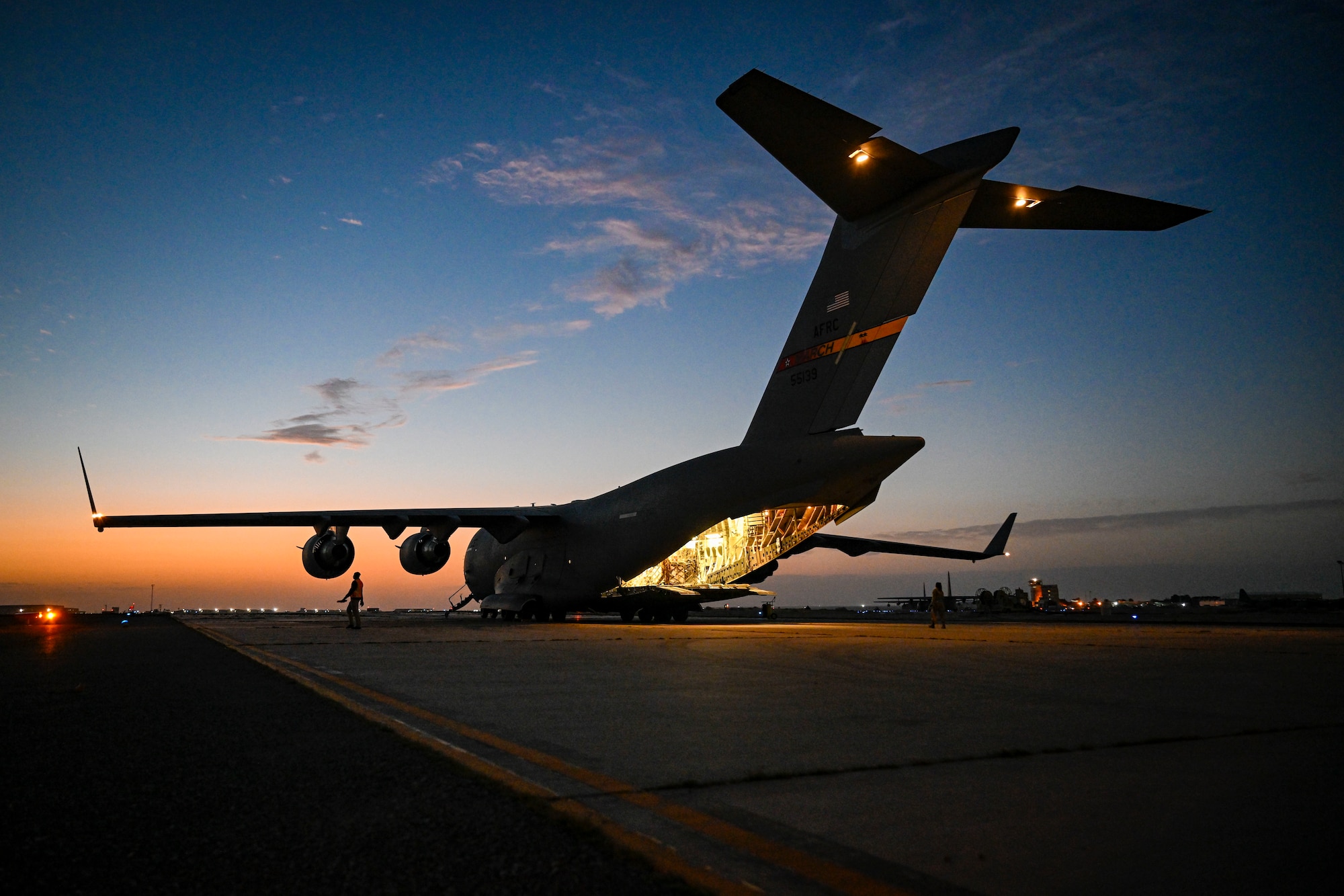 A plane sits parked on a flightline.