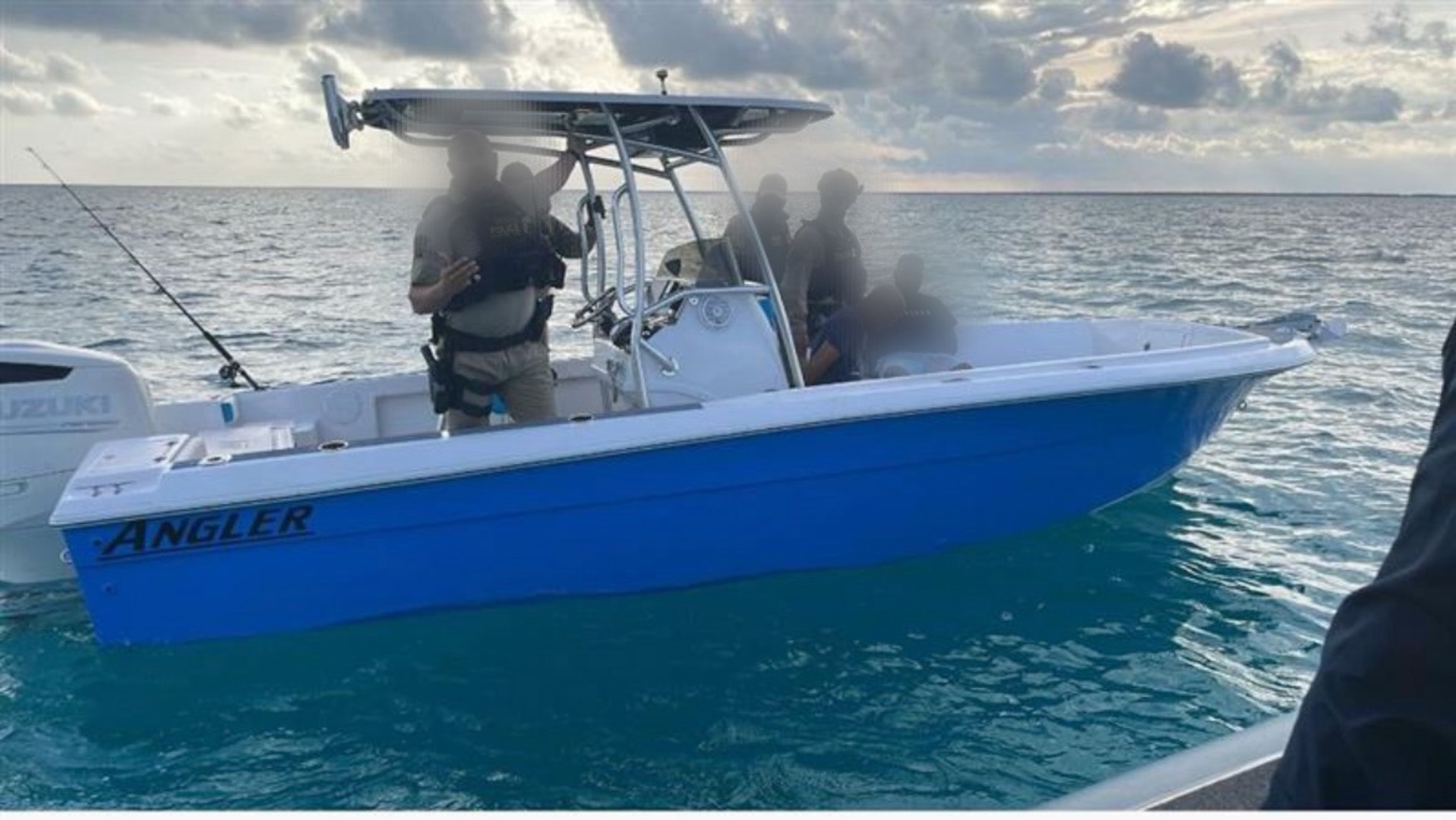 A Customs and Border Protection Air and Marine Operations boat crew alongside one of two recreational vessels involved in a suspected smuggling venture in U.S. territorial waters, Feb. 18, 2025. One suspected smuggler was transferred to Homeland Security Investigations and the remaining 23 aliens onboard were returned to The Bahamas. (Courtesy photo)