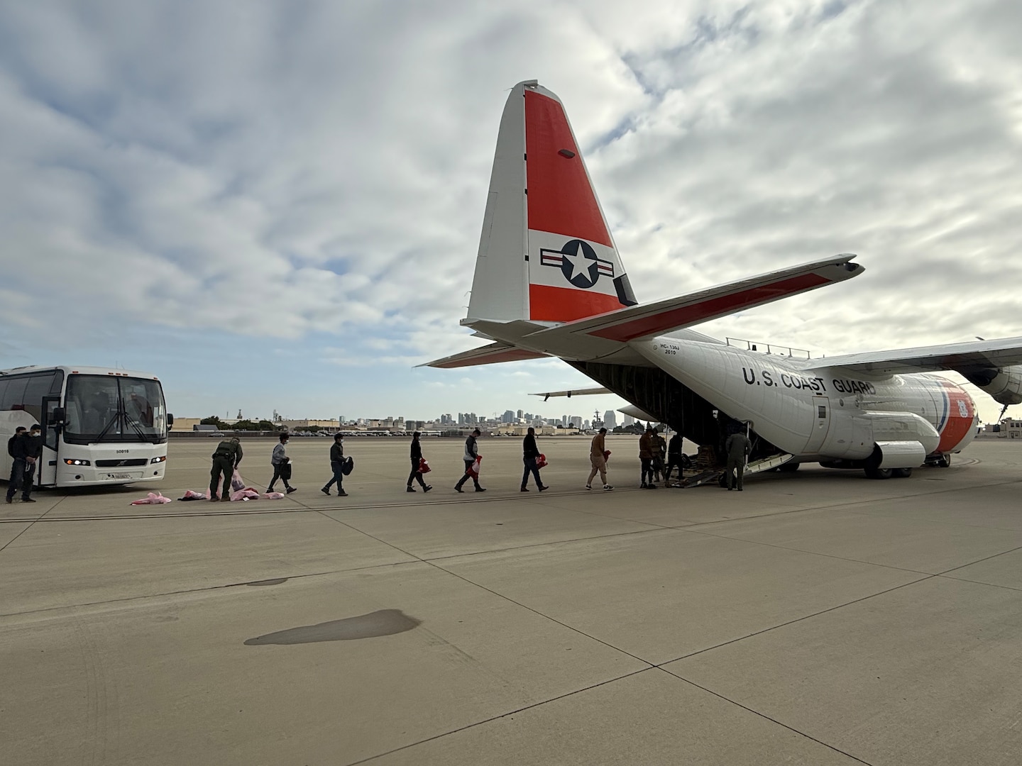 A U.S. Coast Guard C-130 Hercules crew prepares for an alien expulsion flight Feb. 19, 2025.