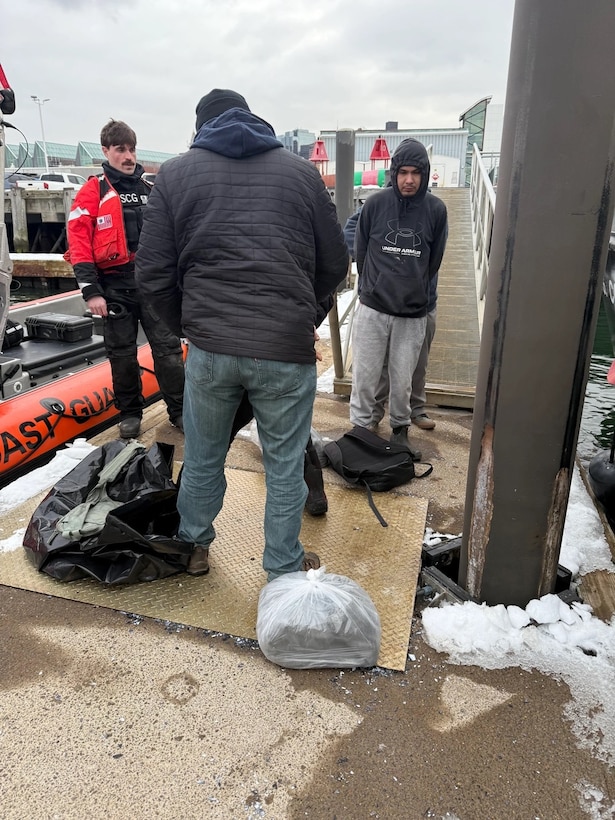 U.S. Coast Guard members secure a detained alien at Coast Guard Base Boston, Feb. 20, 2025.