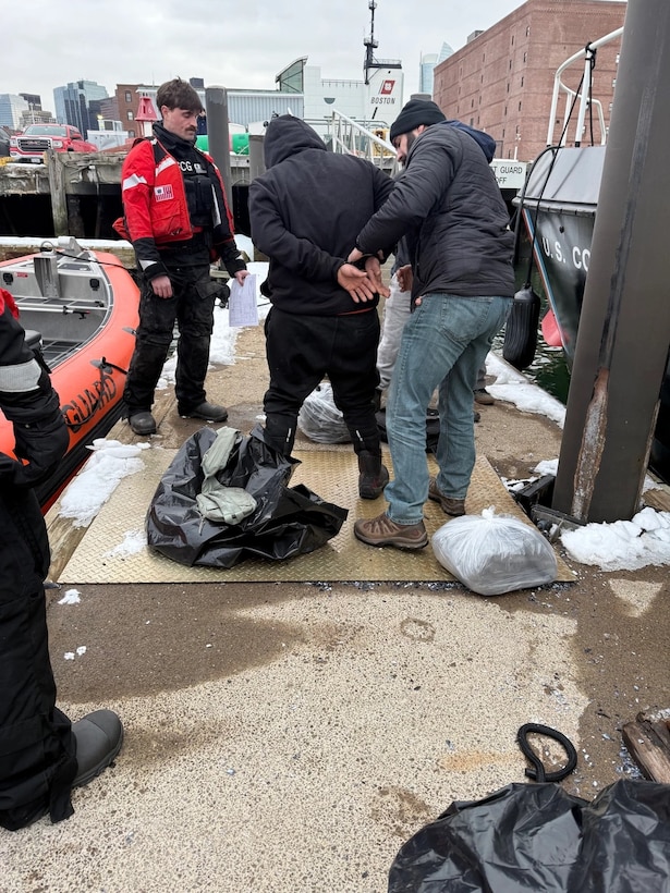 U.S. Coast Guard members secure a detained alien at Coast Guard Base Boston, Feb. 20, 2025.