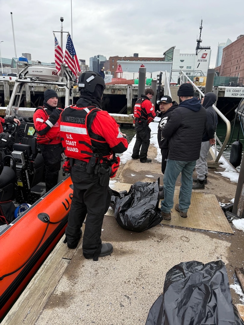 U.S. Coast Guard members secure a detained alien at Coast Guard Base Boston, Feb. 20, 2025.