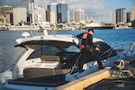 U.S. Coast Guard Fireman Lewis Metcalf, a boarding team member assigned to Coast Guard Station Honolulu, disembarks a yacht and steps onto the pier at Coast Guard Base Honolulu Feb. 21, 2025. A 45-foot Response Boat-Medium crew from Station Honolulu detained a man suspected of stealing the yacht from Kewalo Basin Harbor. (U.S. Coast Guard photo by Petty Officer 2nd Class Tyler Robertson)
