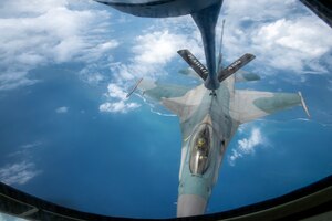 An Indonesian Air Force (IDAF) F-16 Fighting Falcon flies alongside a Hawaii Air National Guard KC-135 Stratotanker assigned to the 203rd Air Refueling Squadron during an air-to-air refueling training mission over Indonesia, Feb. 19, 2025.