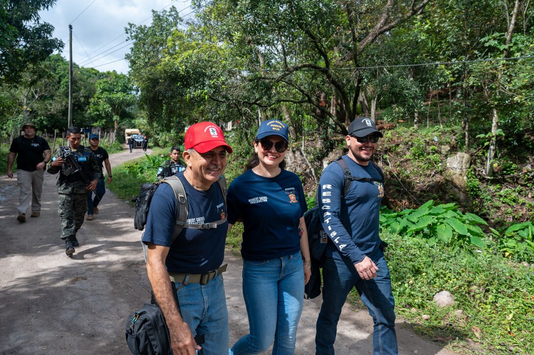Members from Joint Task Force-Bravo hike three miles to deliver food to 80 families in need Feb. 22 in El Llano de la Puerta, Comayagua, Honduras. The Chapel Hike, a volunteer program where service members trek to remote villages carrying essential supplies, has become synonymous with JTF-Bravo's commitment to the Honduran people. (U.S. Air Force photo by Capt. Hillary Gibson)