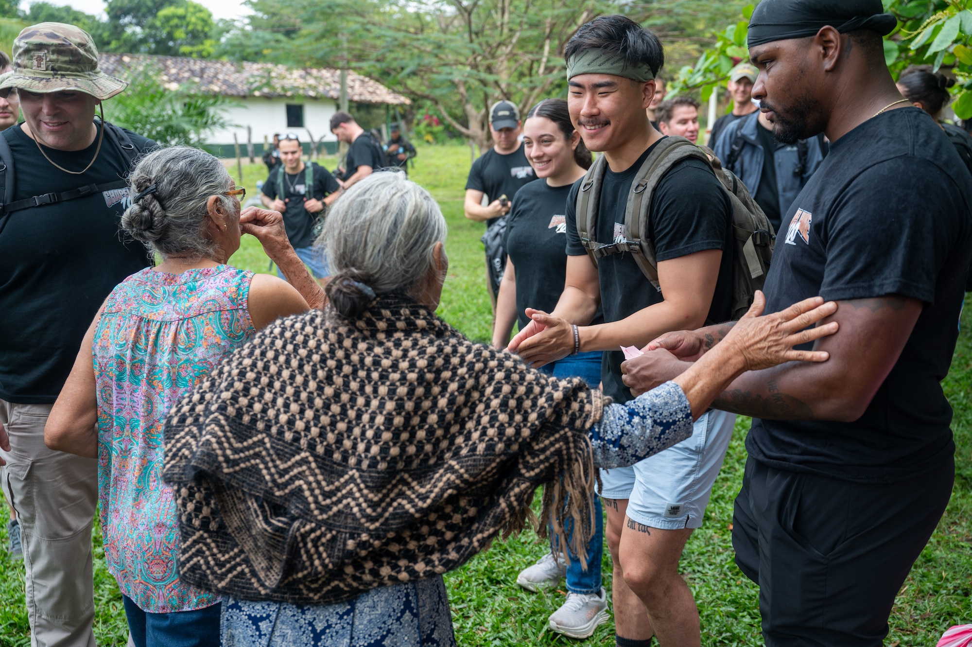 A woman thanks JTF-Bravo members after receiving her food donation during Joint Task Force-Bravo’s 100th Chapel Hike Feb. 22. The Chapel Hike, a volunteer program, has become synonymous with JTF-Bravo's commitment to the Honduran people. (U.S. Air Force photo by Capt. Hillary Gibson)