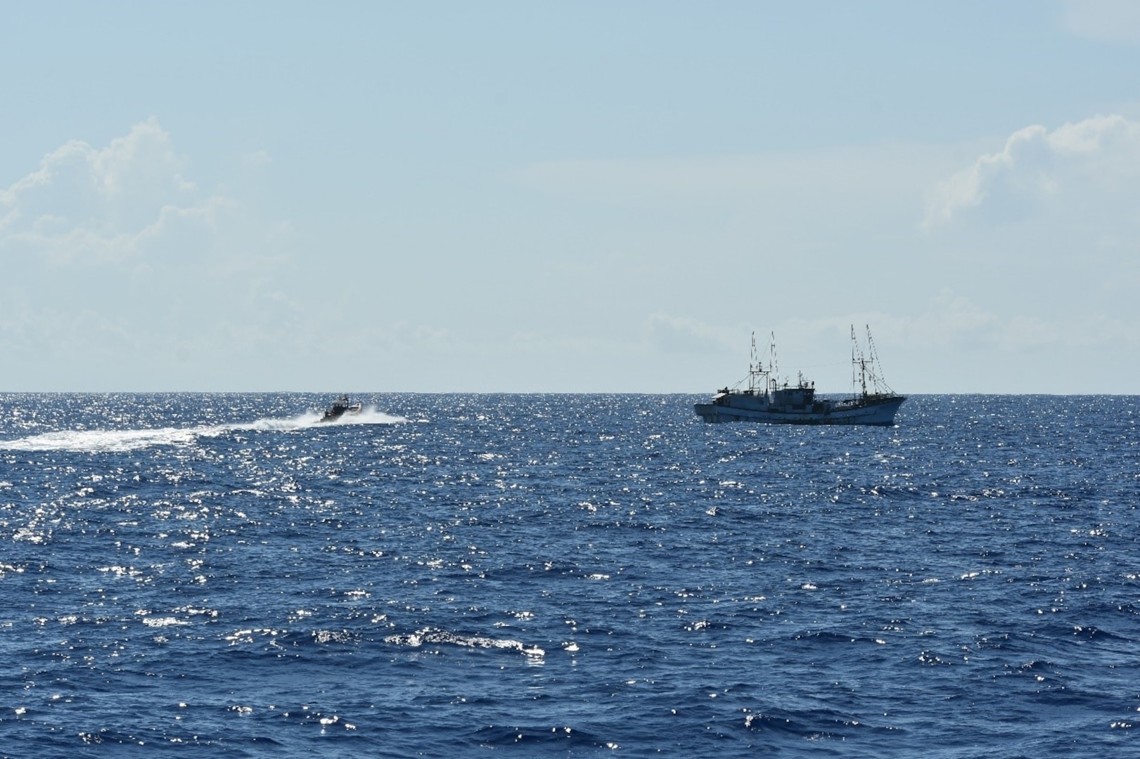 A small boat crew assigned to U.S. Coast Guard Cutter Joseph Gerczak (WPC 1126) prepares to board a U.S.-flagged commercial fishing vessel off the coast of American Samoa Feb. 7, 2025. Due to American Samoa’s status as a U.S. territory, the Coast Guard has the authority to conduct boardings in the U.S. Exclusive Economic Zone surrounding the territory, which extends up to 200 nautical miles offshore. (U.S. Coast Guard photo by Ensign Samuel Carrol)