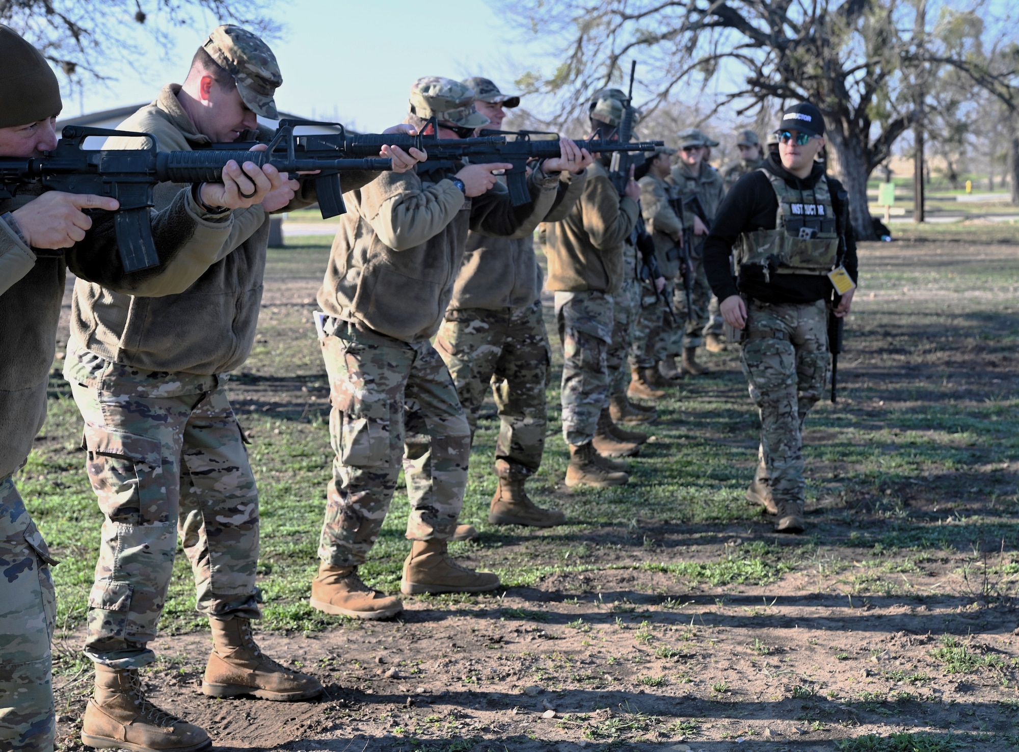 Members assess their ready stance during Small Arms training at Joint Base San Antonio-Lackland, Texas on Feb. 6, 2024. All members who deploy to forward locations must be familiar with small arms in support of effective Force Protection. (US Air Force photo by Alex Dieguez)