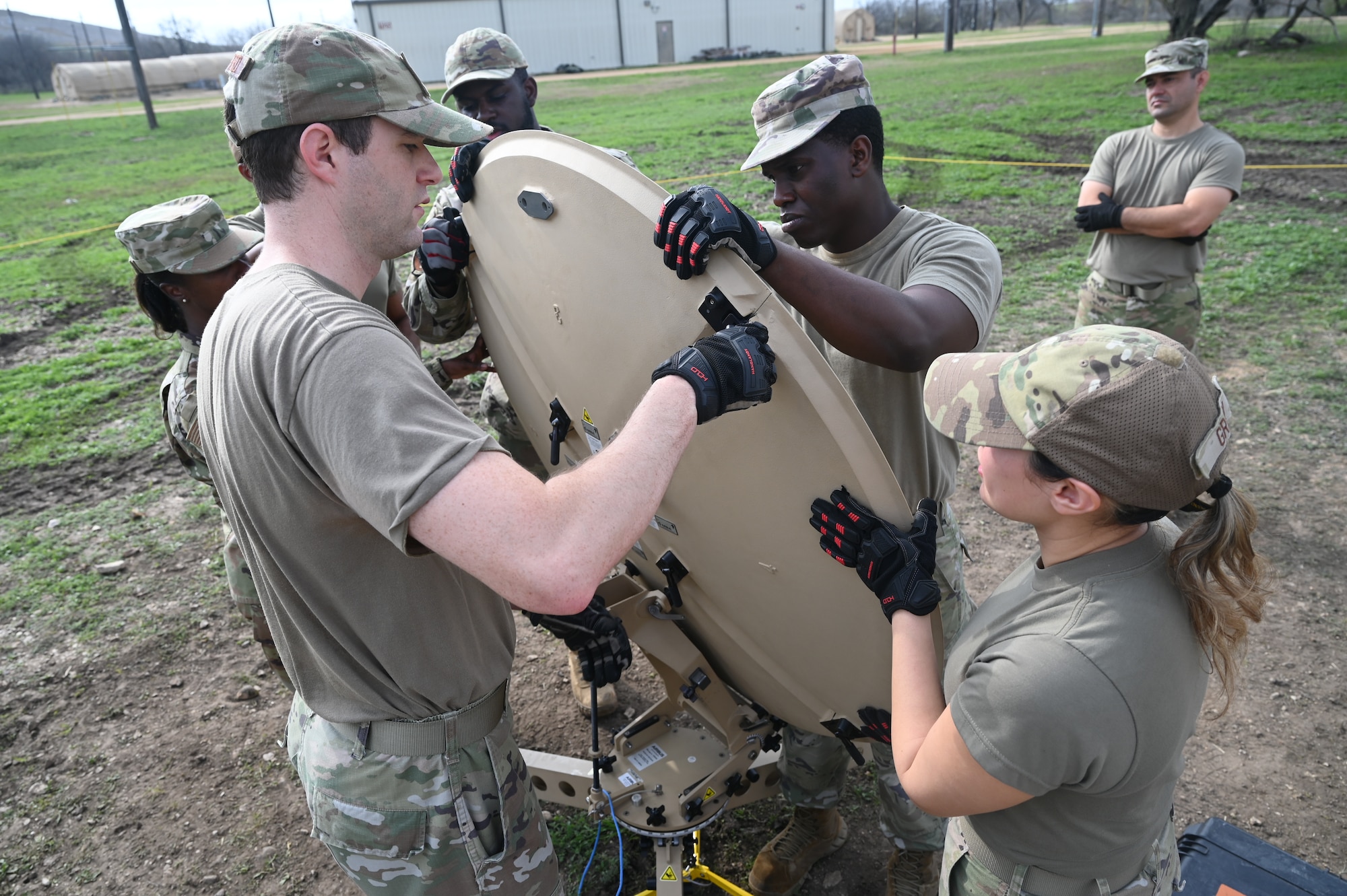 Members of the 960th Cyberspace Wing are instructed through the teardown of expeditionary communications (XCOMM) equipment at Joint Base San Antonio-Lackland, Texas on Feb. 8, 2024. The scale of the military satellite and associated components supports agile repositioning and rapid employment of C2 support. (US Air Force photo by Alex Dieguez)